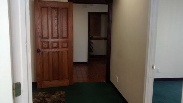 TILE ENTRY AND RECEPTION, 3 OFFICES AND LARGER ROOM.